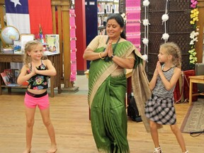Pembroke Public Library's chief executive officer Karthi Rajamani (centre) performed a traditional Indian dance and was joined by Nya Kosmack (left) and Hanna Benn (right) during the 2016 Multicultural Festival. Célina Ip