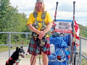 Michael Yellowlees and Luna paused for a break on their cross-Canada walk at the lookout on Highway 17 west of North Bay, Thursday, Sept. 9. The duo is expected to be in the Pembroke/Petawawa area later this week.