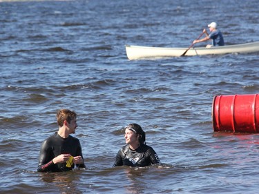 Brady Risteen and Robin McLaughlin head for shore at the conclusion of the 2021 Kiwanis Ottawa River Swim on Sept. 1. In the background Kiwanian Roger Steinke keeps an eye on swim organizer Robert McLaughlin as he completes his three laps.