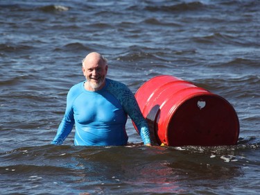 A pretty happy Kiwanis Ottawa River Swim organizer Bob McLaughlin heads for shore with the start/finish barrel. This year's event raised $4,500 for the Kiwanis Club of Pembroke's work for disadvantaged children.