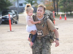 Sgt. Peter Eden of Canadian Special Operations Regiment was met on his way to the finish  of the 2021 Iron Warrior competition in Petawawa by his daughter Abigail. Having rucked, portaged and paddled 42 kilometres, Eden was still all smiles as they crossed the finish line together.