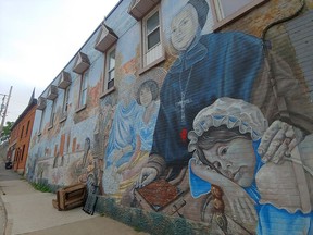 The Marguerite d'Youville and Her Mission mural in downtown Pembroke has become controversial following the recent discovery of unmarked graves of Indigenous children on the grounds of former Indian residential schools. While the Pembroke branch of the Grey Sisters, known as the Grey Sisters of the Immaculate Conception, were not involved in the residential school system, other branches of the Grey Sisters were. d'Youville herself was the first native born Canadian to be declared a saint. She lived and died before the development of the residential school system and is said to have spent her life helping others, regardless of race or economic class. Evidence indicates she may have had First Nations slaves. At that time, slavery was actively practiced in New France. This past summer, the mural was vandalized with d'Youville's image and that of a Grey Sister being hit with red painted hand prints.