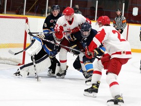 Renfrew Wolves' goalie Sebastian Resar manages a toe save through a crowd as the Pembroke Lumber Kings' Jesse Kirkby (24) and Jack Stockfish (22) look for the loose puck during first period action at the PACC Sept. 19. The Kings edged the Wolves 5-4 in overtime in the final pre-season game for both teams.