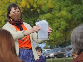 Leigh Miller of the Circle of Turtle Lodge holds up a 'Treaties' map from the Royal Commission on Aboriginal Peoples during a Kairos Blanket Exercise conducting on the Pembroke waterfront on Sept. 30 to mark the first National Day for Truth and Reconciliation.