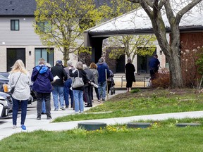 People line up at the COVID-19 vaccination clinic at the Caradoc Community Centre in Mt. Brydges on April 19. Derek Ruttan/Postmedia Network