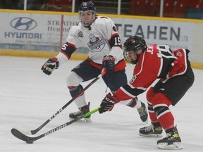 Listowel's Cory Jewitt tries to go wide on Stratford's Danny Heath during the first period of Friday's season-opening game at Allman Arena. Stratford won 6-2.