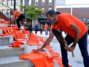 Chief Jason Henry of the Chippewas of Kettle and Stony Point First Nation and Stratford Deputy Mayor Martin Ritsma each lay an orange shirt on the front steps of Stratford City Hall as a way to acknowledge, remember and pay respect to the victims of Canada's residential school system. "Truth is about what happened and what's real. … Reconciliation is about different groups coming to an understanding. … Though both constructs are equally important, truth must come before reconciliation," Henry said Thursday. Galen Simmons/The Beacon Herald/Postmedia Network