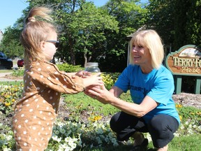 Stella Cicchini, 2, hands over proceeds from her lemonade stand to Laurie Rome with the Sarnia Terry Fox Run committee. Stella made the donation in memory of her aunt. This year's Terry Fox Run fundraiser is being held online and is set for Sept. 19.