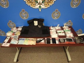 This photo provided by Sarnia police shows drugs and other items allegedly seized Tuesday by officers with a search warrant for an address on Devine Street.