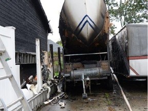 Sarnia police provided this photo of a sailboat and house damaged Saturday morning by a fire.