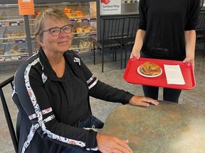 United Way of Sarnia-Lambton board member Kathy Sitter is served a bagel, with the new pumpkin spice cream cheese, by Kaylene Tynan. The Bagel Factory will donate $1 from every dozen bagels sold to the United Way for the month of October. United Way photo