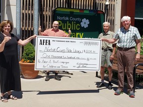 AFFA (Active-Fellowship-Faith-Advocacy) group of Port Dover presented the Norfolk County Public Library with a cheque for $1,206 raised through an adopt-a-book challenge earlier this year. On hand for the presentation at the library's Port Dover branch were, from left, NCPL CEO Heather King, NCPL Board Chair Adam Veri, AFFA members Jim Cation and Bruce Armstrong. CONTRIBUTED