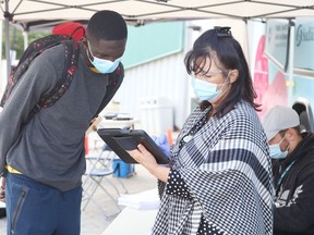 College Boreal student Chris Mabongi, left, attended a mobile vaccination clinic at the campus in Sudbury, Ont. on Thursday September 9, 2021. John Lappa/Sudbury Star/Postmedia Network