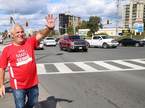Nickel Belt Liberal candidate Marc Serre waves to motorists at the intersection of Regent Street and Long Lake Road while campaigning in Greater Sudbury, Ont. on Friday September 10, 2021. John Lappa/Sudbury Star/Postmedia Network