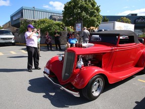 Serena Dick takes a photo of a 1933 Ford Coupe at the Sudbury CARes car show at the Verdicchio Ristorante parking lot on Kelly Lake Road in Sudbury, Ont. on Sunday September 12, 2021. The event, which had more than 500 cars pass through the show, raised a total of $10,769.10 in support of the Sudbury Food Bank and the NEO Kids Foundation. The car show was organized by Wade Hein, of Pass It On Undercoating, and Joseph Gregorini, of Ponterio Developments. John Lappa/Sudbury Star/Postmedia Network