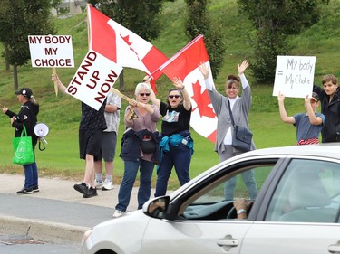 Protesters take part in a rally against vaccine passports and vaccine mandates in workplaces during a rally on Paris Street near Health Sciences North in Sudbury, Ont. on Monday September 13, 2021. Close to 50 people participated in the event. John Lappa/Sudbury Star/Postmedia Network