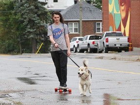 Neenah the dog pulls Christopher Rainville on his skateboard in a light rain in Sudbury, Ont. on Tuesday September 14, 2021. Environment Canada said Greater Sudbury can expect mainly cloudy skies with a 30 per cent chance of showers on Wednesday. The temperature should reach 19 C. John Lappa/Sudbury Star/Postmedia Network