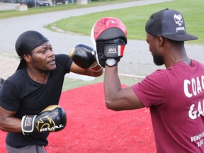 Fitness trainer Gaby Onadja, right, encourages Yung Kabc during a round of fitness boxing at Queen's Athletic Field in Sudbury, Ont. on Wednesday September 15, 2021. John Lappa/Sudbury Star/Postmedia Network