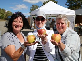 Patricia Gagnier, middle, and her daughters, Michelle Boivin, left, and Micheline Tessier, display a variety of apples they purchased for eating and baking at the Sudbury Market at York Street and Paris Street in Sudbury, Ont. on Thursday September 16, 2021. The market is open on Thursdays from 2 p.m. to 6 p.m. and Saturdays from 9 a.m. to 2 p.m. John Lappa/Sudbury Star/Postmedia Network