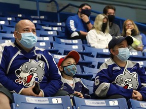 Fans look on during OHL exhibition action featuring the Sudbury Wolves and the Peterborough Petes at the Sudbury Community Arena in Sudbury, Ont. on Friday September 17, 2021. Health units in Northern Ontario have expanded proof of vaccination requirements for those attending indoor sports.