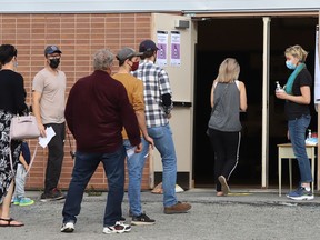 People line-up to vote in the federal election at Walden Public School in Lively, Ont. on Monday September 20, 2021. John Lappa/Sudbury Star/Postmedia Network