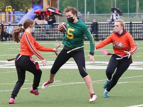 Halle Bertrim, middle, of Lockerby Vikings, attempts to run between Cianna Avery, left, and Mila Pyoli, of Lasalle Lancers, during high school flag football action at James Jerome Sports Complex in Sudbury, Ont. on Wednesday September 22, 2021. Vikings won 26-0. John Lappa/Sudbury Star/Postmedia Network