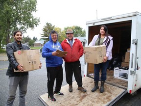 Jr. Nootchtai, left, Ward 2 Coun. Michael Vagnini, Mike Naponse and Nadine Nootchtai load clothing items into a trailer at Cornerstone Community Church in Lively Ont. on Thursday September 23, 2021. The clothing was collected recently at a drop-off event at the Walden Home Hardware in Lively. The items are destined for Atikameksheng Anishnawbek First Nation. John Lappa/Sudbury Star/Postmedia Network