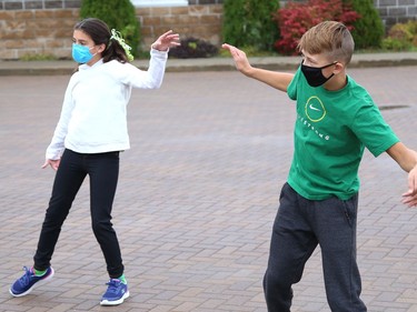 Allison Ouimet, left, and Ty Belanger, of Ecole Ste-Marie, take part in a celebration with classmates by dancing and singing to music at a celebration for Franco-Ontarian Day in Azilda, Ont. on Friday September 24, 2021. All schools in OntarioÕs 12 French-language school boards participated in a 90-minute virtual celebration on Friday. Students from Conseil scolaire catholique Nouvelon schools participated in the mega celebration by watching a live broadcast at mondrapeaufranco.ca. The broadcast can be viewed until October 1. John Lappa/Sudbury Star/Postmedia Network