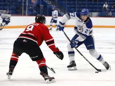 Quentin Musty, right, of the Sudbury Wolves, attempts to fire the puck past Sam Sedley, of the Owen Sound Attack, during OHL exhibition action at the Sudbury Community Arena in Sudbury, Ont. on Friday September 24, 2021. John Lappa/Sudbury Star/Postmedia Network