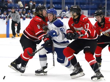 David Goyette, middle, of the Sudbury Wolves, attempts to skate between Andrew Perrott, left, and Lorenzo Bonaiuto, of the Owen Sound Attack, during OHL exhibition action at the Sudbury Community Arena in Sudbury, Ont. on Friday September 24, 2021. John Lappa/Sudbury Star/Postmedia Network