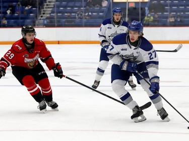 Quentin Musty, right, of the Sudbury Wolves, skates past Ethan Burroughs, of the Owen Sound Attack, during OHL exhibition action at the Sudbury Community Arena in Sudbury, Ont. on Friday September 24, 2021. John Lappa/Sudbury Star/Postmedia Network