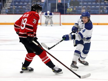 Nathan Ribau, right, of the Sudbury Wolves, attempts to fire the puck past Colby Barlow, of the Owen Sound Attack, during OHL exhibition action at the Sudbury Community Arena in Sudbury, Ont. on Friday September 24, 2021. John Lappa/Sudbury Star/Postmedia Network