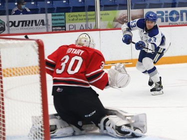 Liam Ross, right, of the Sudbury Wolves, fires the puck past goalie Corbin Votary, of the Owen Sound Attack, during OHL exhibition action at the Sudbury Community Arena in Sudbury, Ont. on Friday September 24, 2021. John Lappa/Sudbury Star/Postmedia Network