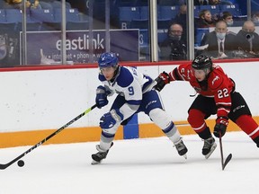 Alex Assadourian, left, of the Sudbury Wolves, skates past Cal Uens, of the Owen Sound Attack, during OHL exhibition action at the Sudbury Community Arena in Sudbury, Ont. on Friday September 24, 2021. John Lappa/Sudbury Star/Postmedia Network