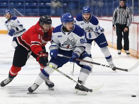 David Goyette, right, of the Sudbury Wolves, and Logan Lesage, of the Owen Sound Attack, battle for the puck during OHL exhibition action at the Sudbury Community Arena in Sudbury, Ont. on Friday September 24, 2021. John Lappa/Sudbury Star/Postmedia Network