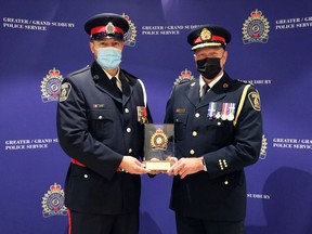 Const. Jon Barry receives a Heroic Action Award from Greater Sudbury Police Chief Paul Pedersen. Supplied