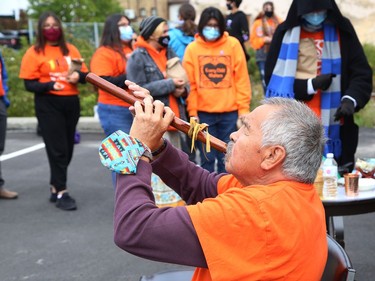 Elder Frank Ozawagosh plays a flute at a ceremony marking National Day for Truth and Reconciliation and Orange Shirt Day at the N'Swakamok Native Friendship Centre in Sudbury, Ont. on Thursday September 30, 2021. John Lappa/Sudbury Star/Postmedia Network