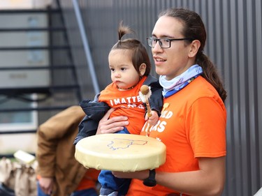 Christian Kaiser-Fox and his son, Orion, 1, participate in a ceremony marking National Day for Truth and Reconciliation and Orange Shirt Day at the N'Swakamok Native Friendship Centre in Sudbury, Ont. on Thursday September 30, 2021. John Lappa/Sudbury Star/Postmedia Network