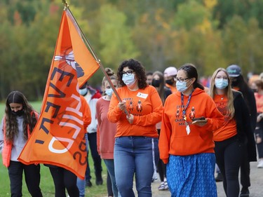 Teacher Loretta Cuda and Indigenous support worker Shannon Agowissa lead a walk in honour of the life of Chanie Wenjack at St. Benedict Catholic Secondary School in Sudbury, Ont. as part of National Day for Truth and Reconciliation and Orange Shirt Day on Thursday September 30, 2021. Chanie ran away from his residential school near Kenora at age 12 in 1966, and died from hunger and exposure. The educational walk also raised awareness of the true history of residential schools. John Lappa/Sudbury Star/Postmedia Network