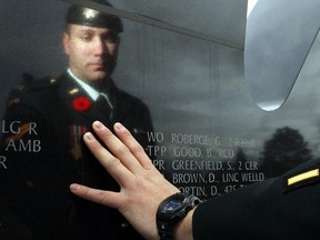Cpl. Andrew Knisley -- who had his arm damaged and entire right leg amputated after being hit by an IED in Afghanistan -- visits the Afghanistan memorial at CFB Petawawa. One of the names inscribed on the wall of Canadian soldiers killed in action there is Gaetan Roberge, his superior officer and colleague, who Andrew credits with saving his life on one occasion. "He was my boss, but, more than that, he was my friend," he said.