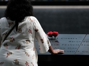 NEW YORK, NEW YORK - AUGUST 31: People pay their respects at the September 11 Memorial at Ground Zero on August 31, 2021 in New York City.