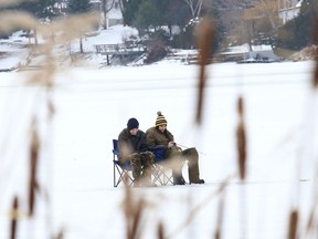 In this file photo, Jesse Teklenburg, left, and Philippe Racette try their luck at ice fishing on Minnow Lake. Ward 11 Coun. Bill Leduc had hoped to get a skating oval for the lake, but council turned home down.