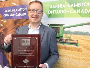 Stephen Thompson, CEO of the Sarnia-Lambton Economic Partnership, holds a previous award the agency received for being named one of Canada's Best Locations by Site Selector magazine. The agency made the list again recently, for the fourth year in a row. File photo/Postmedia