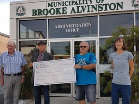 From left, Don McGugan and Mayor Dave Ferguson, with the Brooke-Alvinston Community Fund committee, deliver a donation to Jim Breen and Patsy Ikert of the Hope Alvinston Ministries camp program. Handout