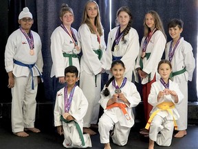 Members of the Sarnia Olympic Taekwondo academy showcase medals earned at online competitions in Austria and Canada. Front row: Julian Bachhus (left), Vanshi Shah and Quinn Kennedy. Back row, Jashandeep Singh (left), Ryan Knight, Eilidh Deery, Carmendy Bambury, Anika Botma and Quinn Clarke. Handout/Sarnia This Week