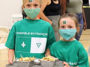 Franco-Ontarian Day revelers Madison, 7, and Kylie, 5, hold authentically-sourced poutine made by Big Daddy's Chip Truck. Carl Hnatyshyn/Sarnia This Week
