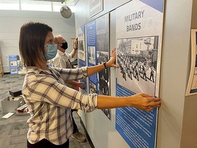 Lambton County Archives' Nicole Aszalos installs the new History of Community Concert Bands in Lambton County exhibition with Lambton Concert Band's Don Vander Klok.Handout/Sarnia This Week