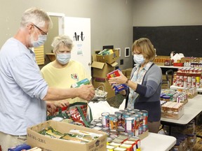 South Porcupine Food Bank volunteers, from left, Mike Cartan, Barbara Lanthier and Liz Dellerede, were preparing some grocery bags for their client families on Tuesday.
