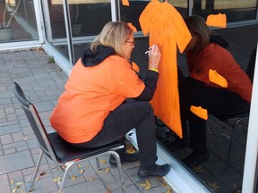 Brenda Beaven, a community liaison co-ordinator at Timmins Police Service, works on paintings that aim to raise awareness of Orange Shirt Day,

Supplied