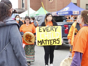 Many of the participants in the seventh-annual Orange Shirt Day walk in Timmins brought their own placards and signs including Feather Metat.

RICHA BHOSALE/The Daily Press